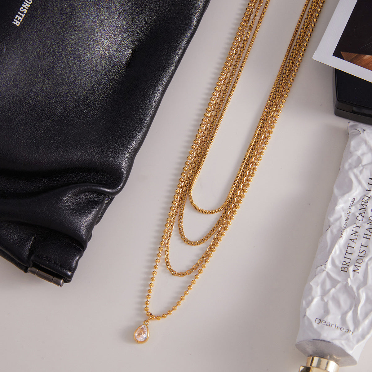 Gold tone stainless steel multi layer necklace flat lay display