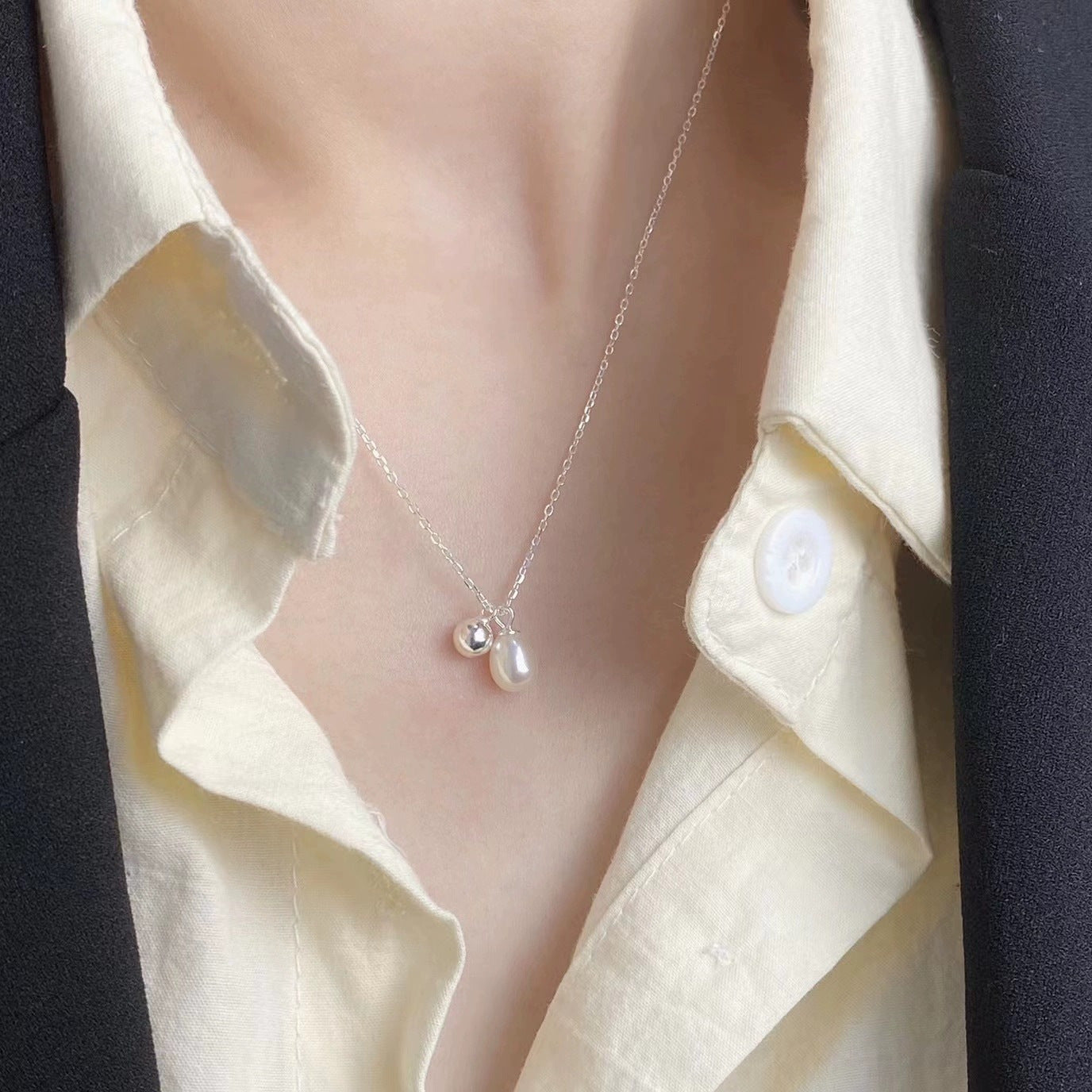 925 silver natural pearl necklace worn with small polished silver ball charm