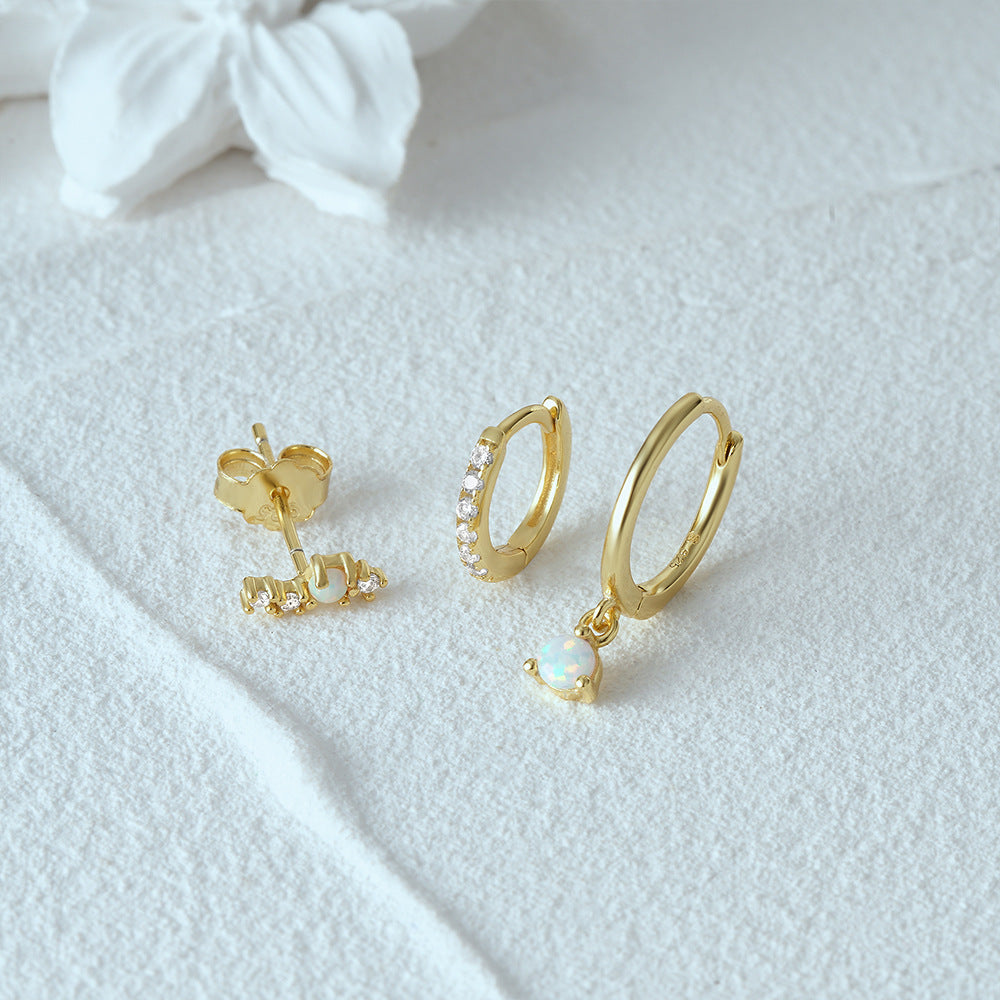 Professional product photography of premium S925 silver opal earring set on a white textured background.