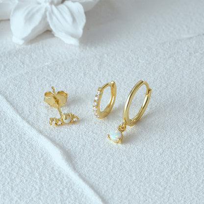 Professional product photography of premium S925 silver opal earring set on a white textured background.