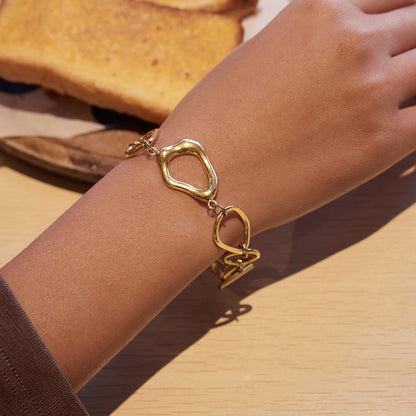 Gold t bar bracelet organic openwork link close up on wrist