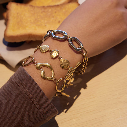 Organic shape link bracelet gold t bar closure minimal styling on wrist