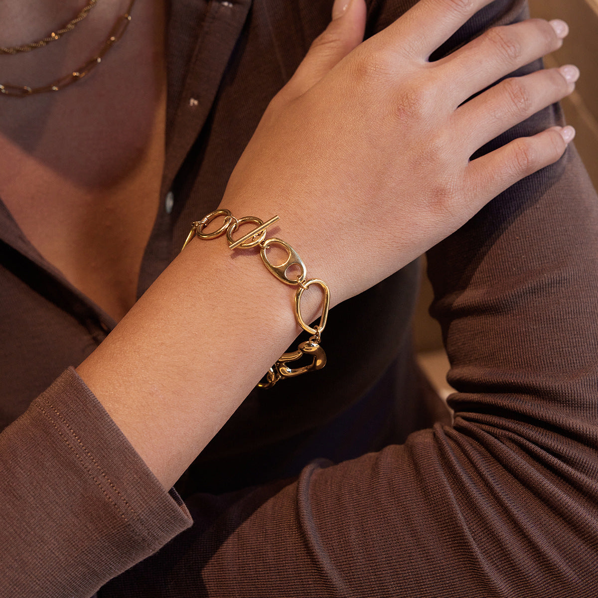 Gold t bar bracelet organic shape link bracelet stacked style on wrist
File name