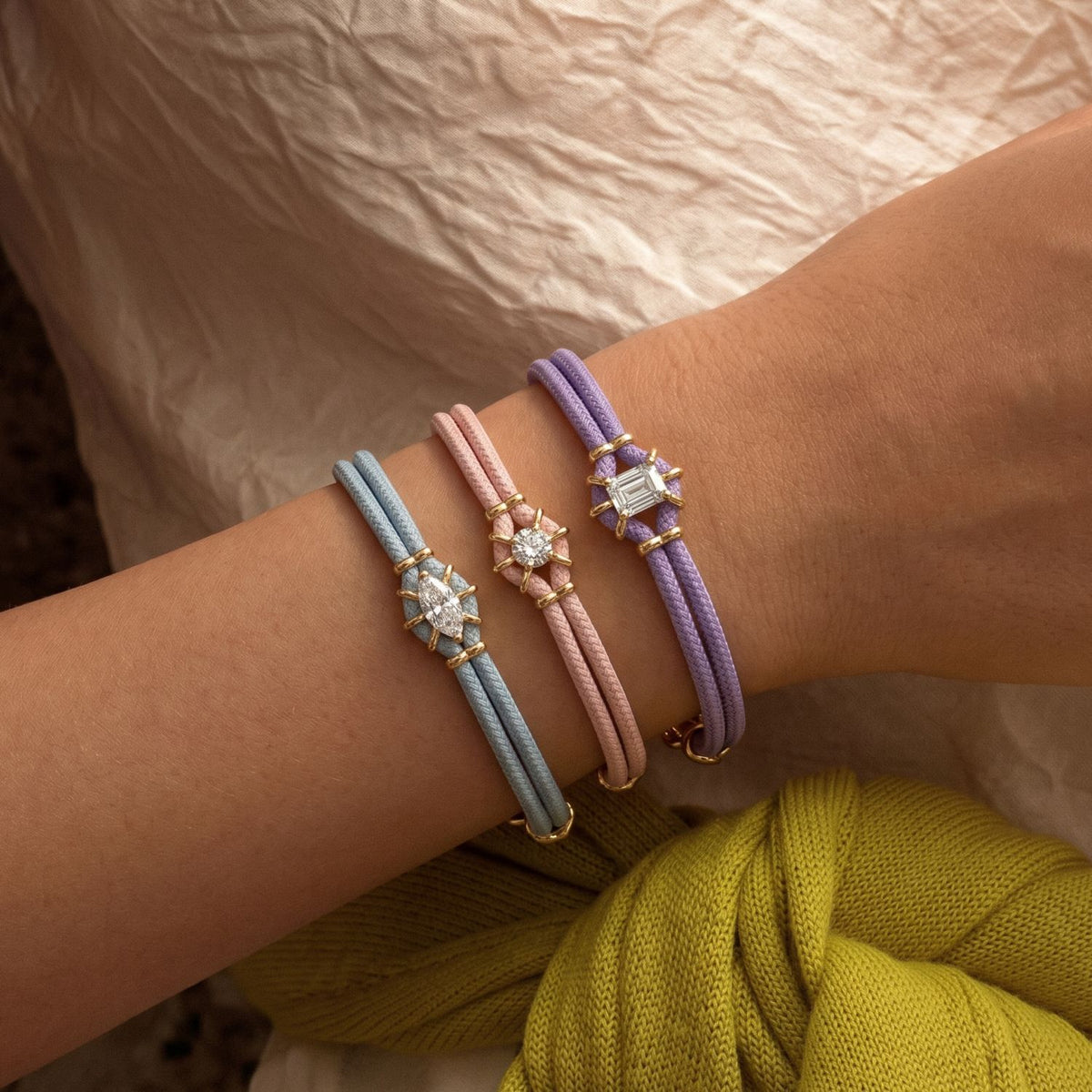Pastel braided bracelets; gold metal bracelet not included