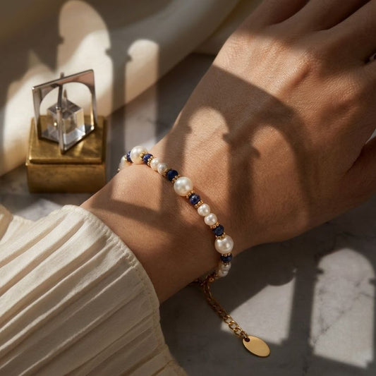 Pearl beaded bracelet with blue stone accents gold tone spacers 