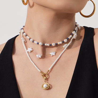 model wearing pearl pendant beaded necklace stainless steel