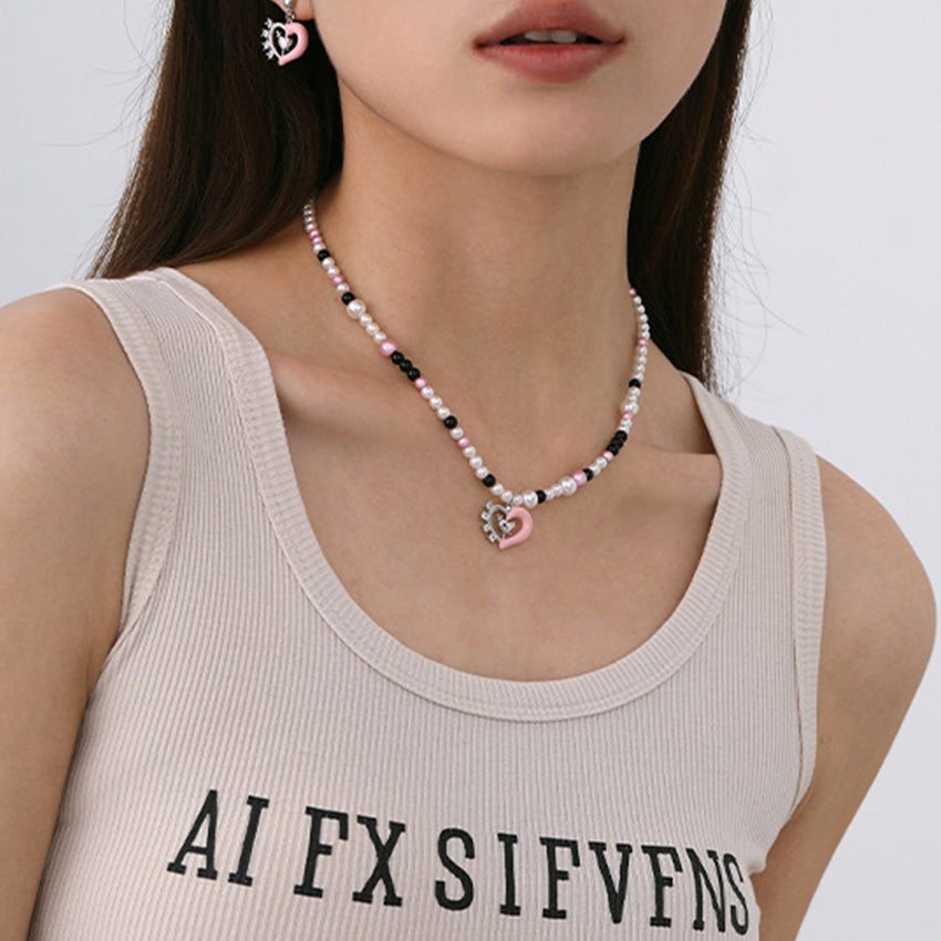 Model wearing a pink heart pearl beaded necklace and matching earrings