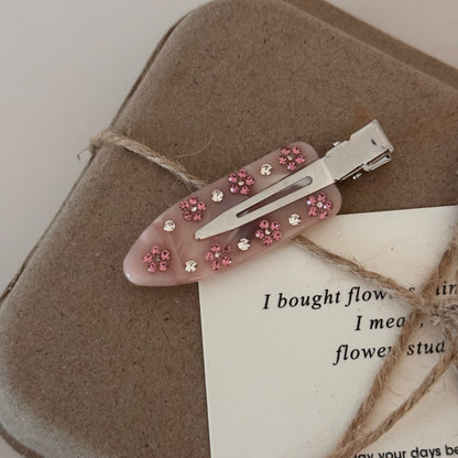 Korean hair clips with pink crystal flower on marble acetate barrette.
