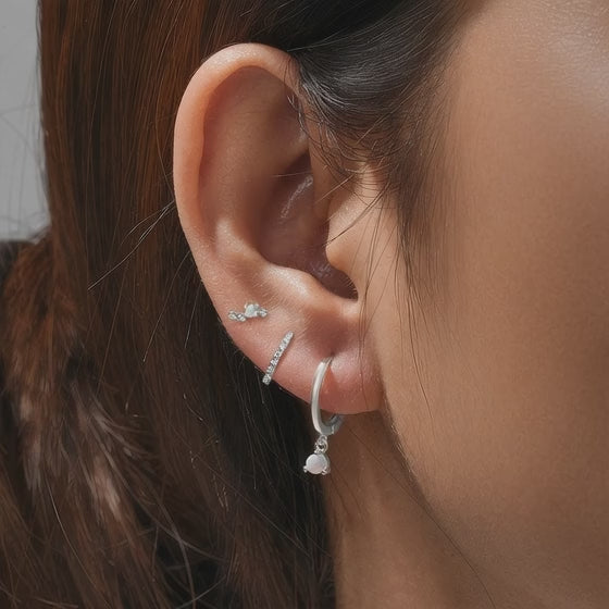 Model demonstration of the silver S925 opal earring set showing how to stack multiple piercings with JR Fashion Accessories.