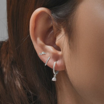 Model demonstration of the silver S925 opal earring set showing how to stack multiple piercings with JR Fashion Accessories.