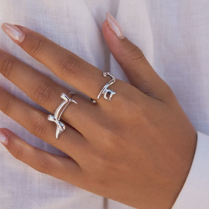 Model wearing gold dachshund and cat open rings for minimal animal themed styling