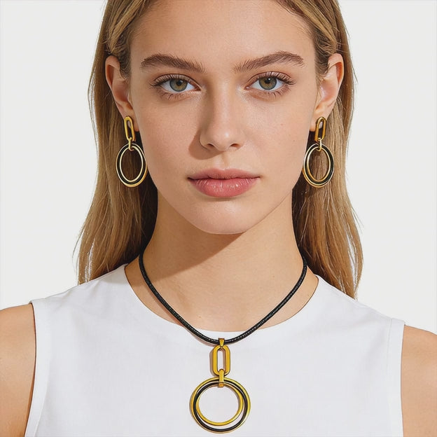 Video showing wholesale stainless steel necklace and earring set in black and gold tone for gift shops and resale in 5 sets