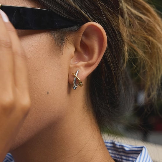 Gold and silver tone stainless steel crossed line earrings movement and design details showcase