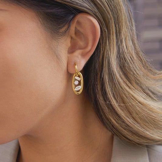 Model wearing gold tone geometric double hoop oval link zircon earrings