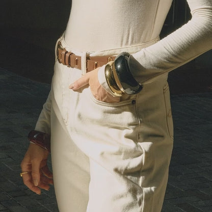 Model wearing wide resin bangles showing glossy finish and stacked styling in motion