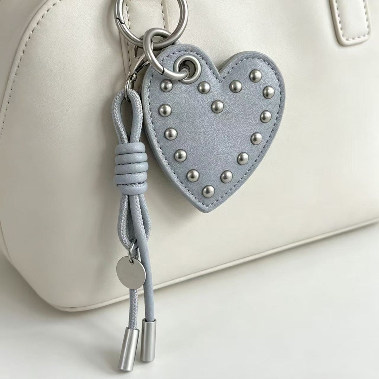 Light blue PU leather heart bag charm with silver studs and tassel