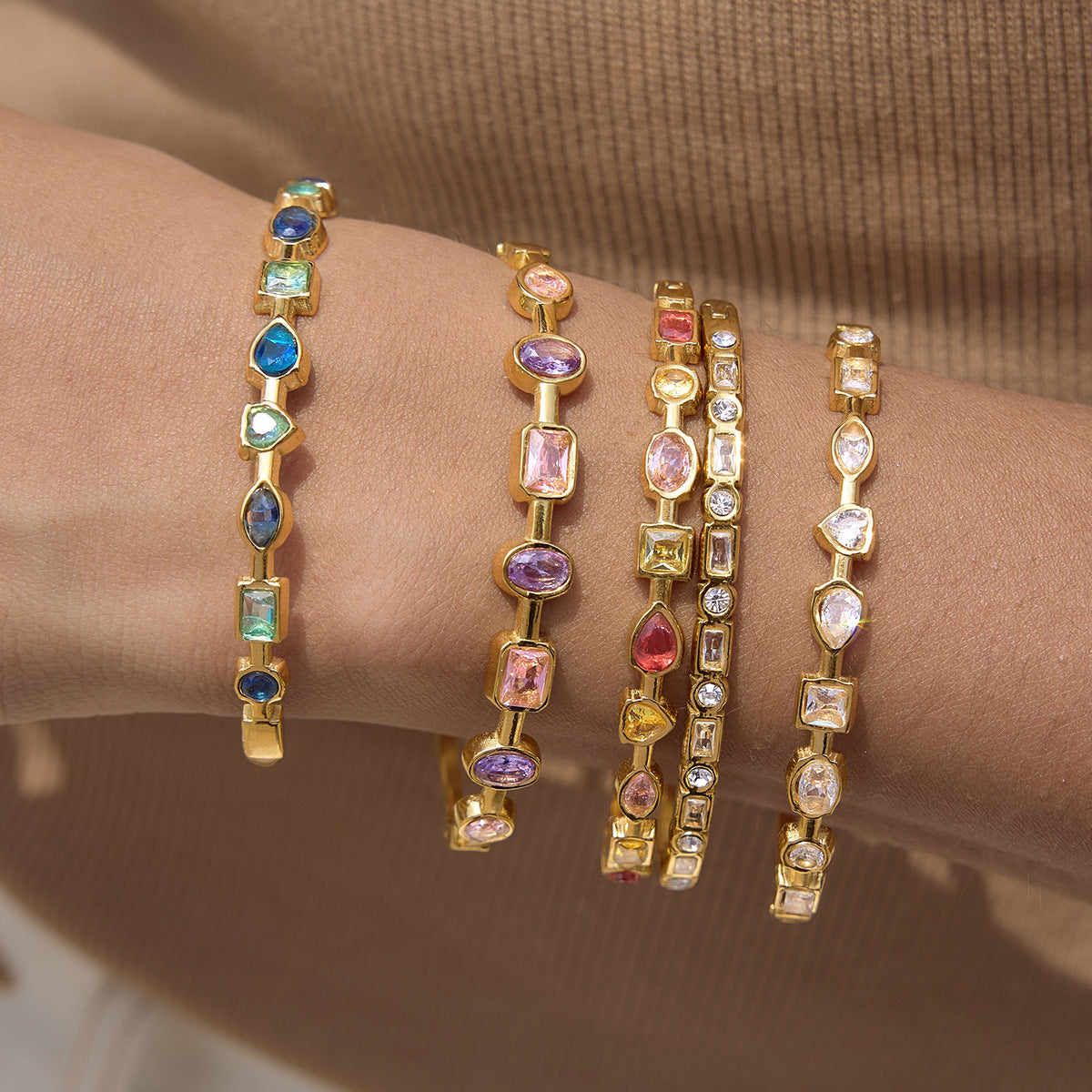Gold rainbow gemstone bangles in blue pink clear and multicolor options