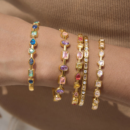 Gold rainbow gemstone bangles in blue pink clear and multicolor options