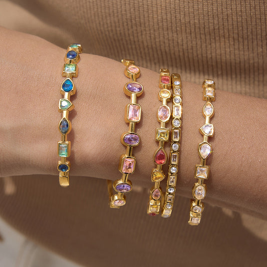 Gold rainbow gemstone bangles in blue pink clear and multicolor options
