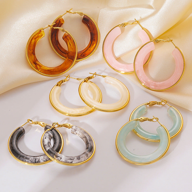 Five piece wholesale resin hoop earrings with gold tone metal frame in pink cream and blue