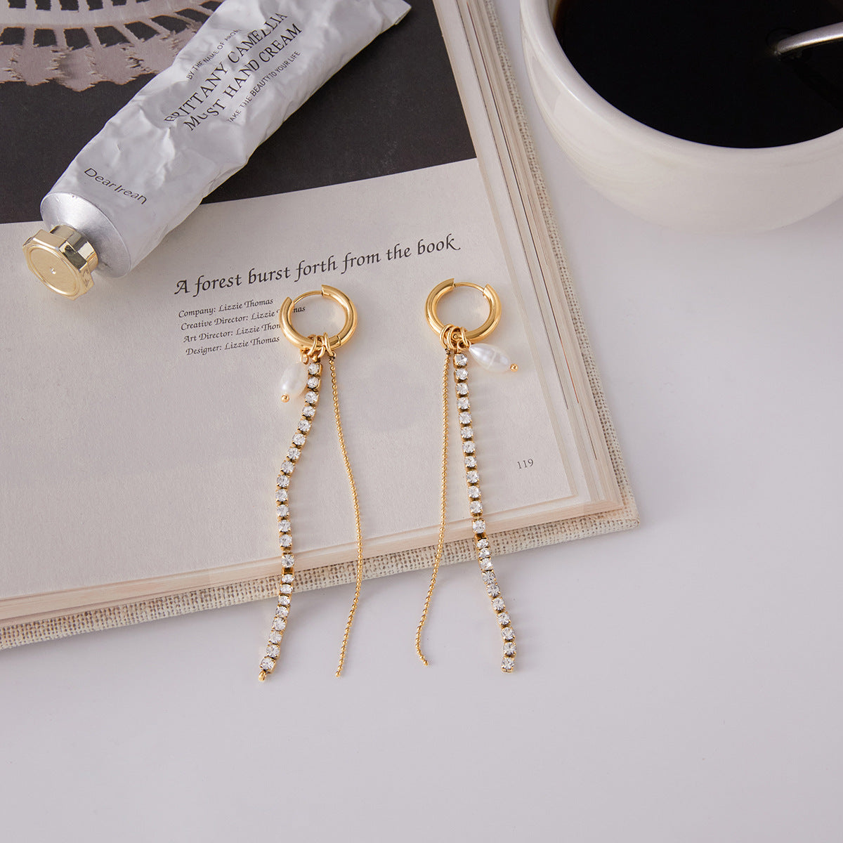 Elegant gold stainless steel rhinestone pearl tassel earrings close up