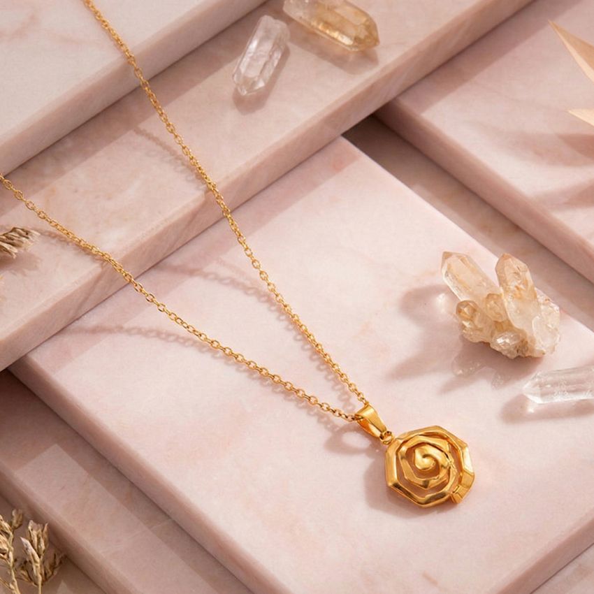 gold plated stainless steel rose flower pendant necklace displayed on stone background
