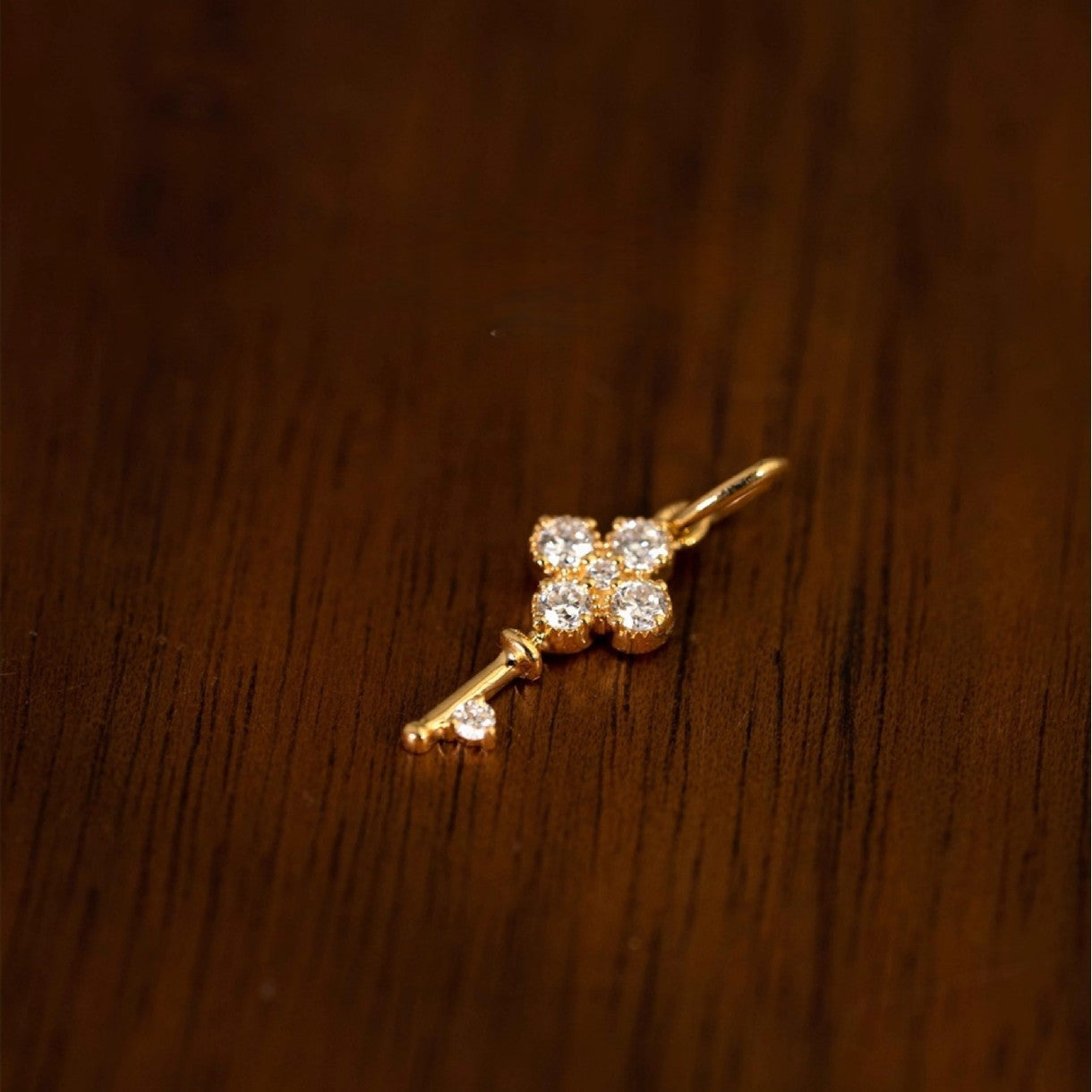 S925 18K gold plated clover key zircon necklace displayed on wood background for boutique resale