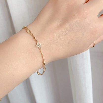S925 gold plated four petal cubic zirconia bracelet displayed on a wrist