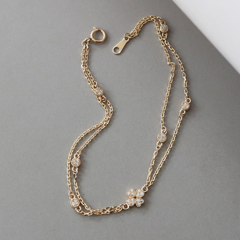  S925 gold plated double chain bracelet with four petal flower and cubic zirconia details