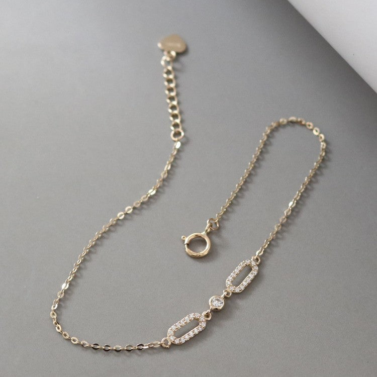 Front view of gold plated S925 oval cubic zirconia chain bracelet with extension clasp