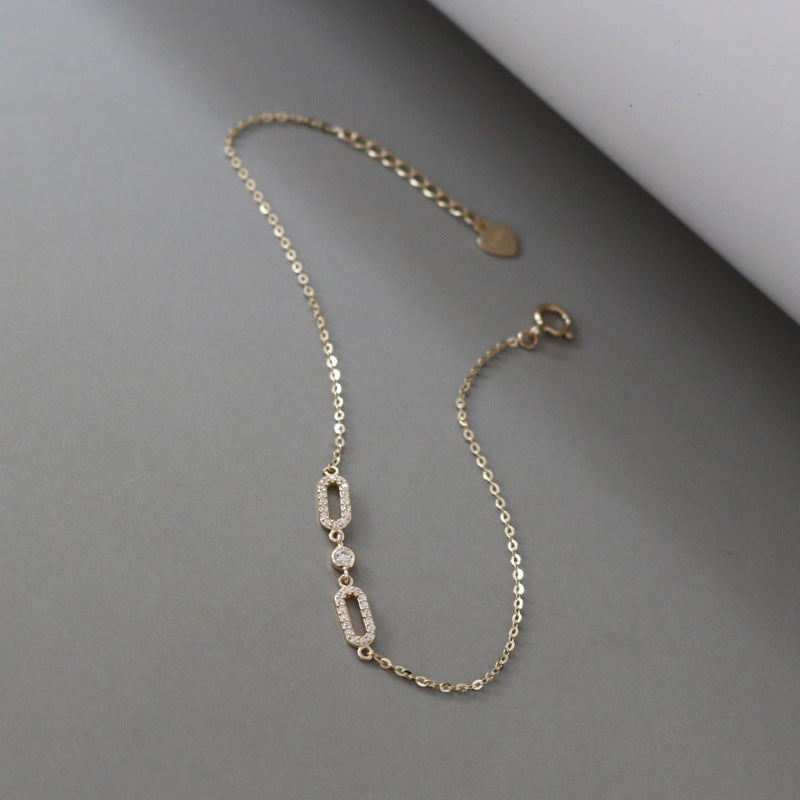 Diagonal product view of delicate S925 gold plated oval cubic zirconia bracelet