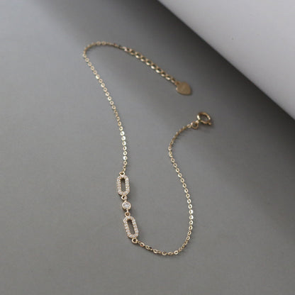 Diagonal product view of delicate S925 gold plated oval cubic zirconia bracelet