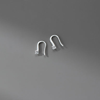 Minimalist sterling silver hook earrings featuring sparkling cubic zirconia