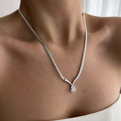model wearing minimalist snake chain necklace with teardrop zircon pendant
