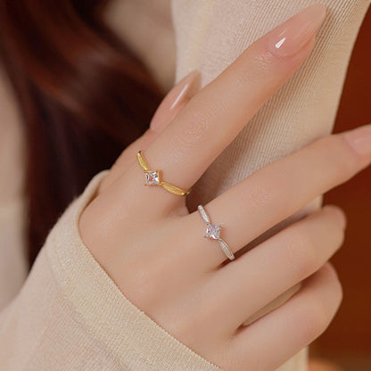 Two adjustable silver rings for women, one gold and one silver, featuring square CZ stones on a hand.