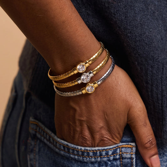 Stainless steel segmented bangle with round cubic zirconia