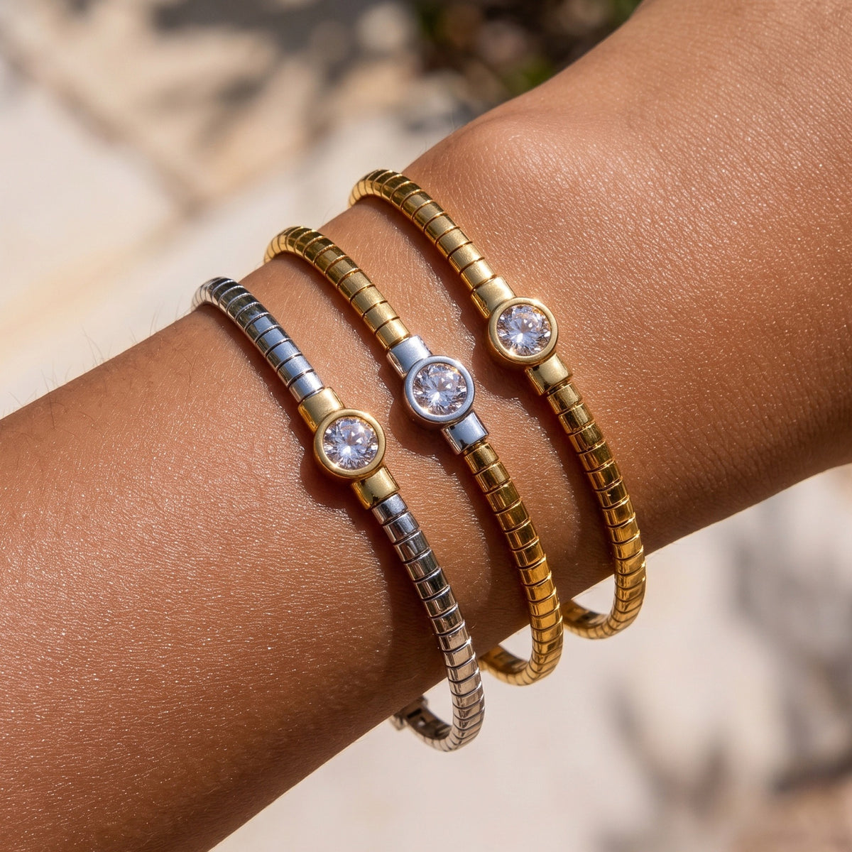 Stainless steel segmented bangle with round cubic zirconia