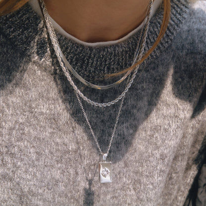 Model wearing stainless steel star rectangle pendant layered necklace