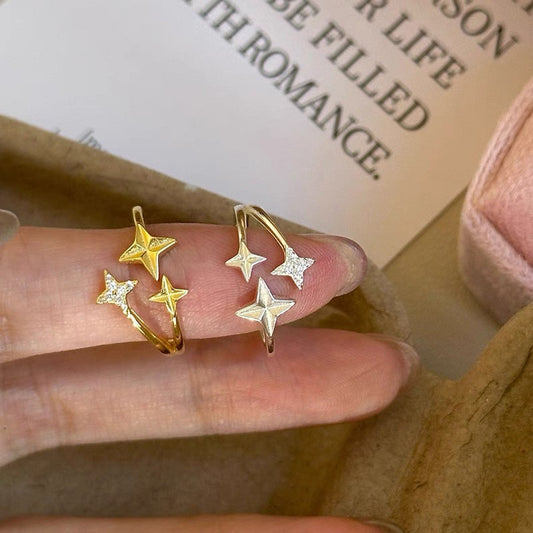 Gold tone and silver tone S925 four point star wrap rings with pavé accents