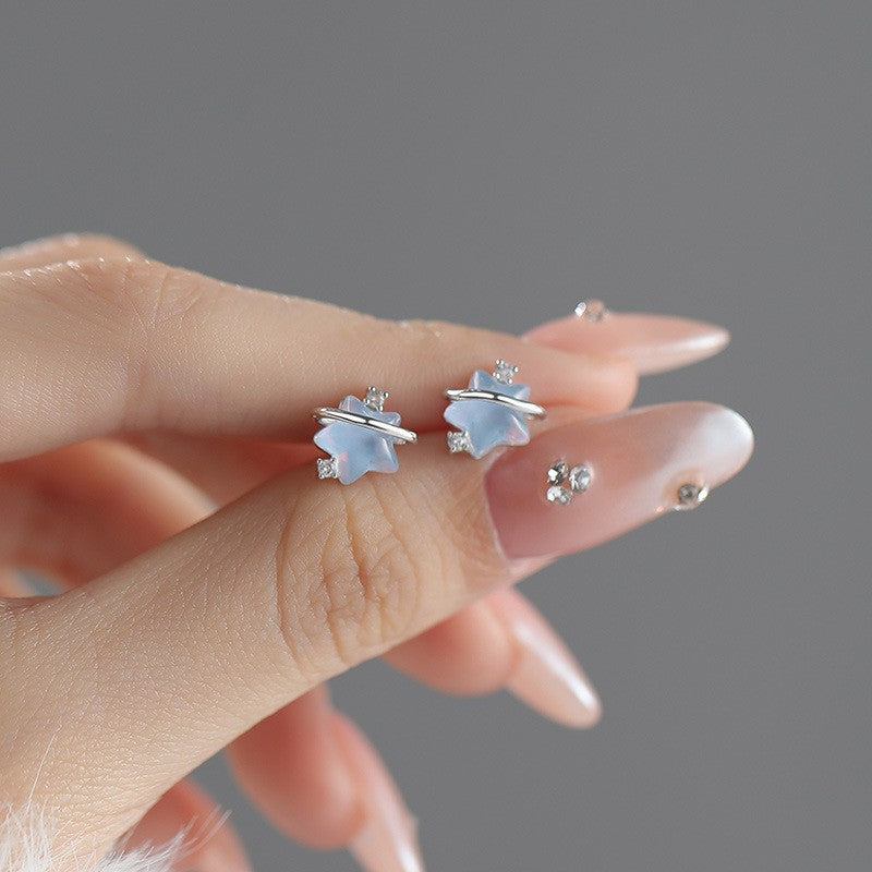 Close up of iridescent planet stud earrings on fingers jewelry accessories wholesale JR Fashion Accessories