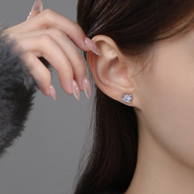 Minimalist moonstone star earrings worn on ear for elegant boutique jewelry style
