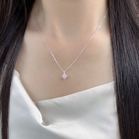 Model wearing a 925 sterling silver pink zircon four leaf clover pendant necklace.