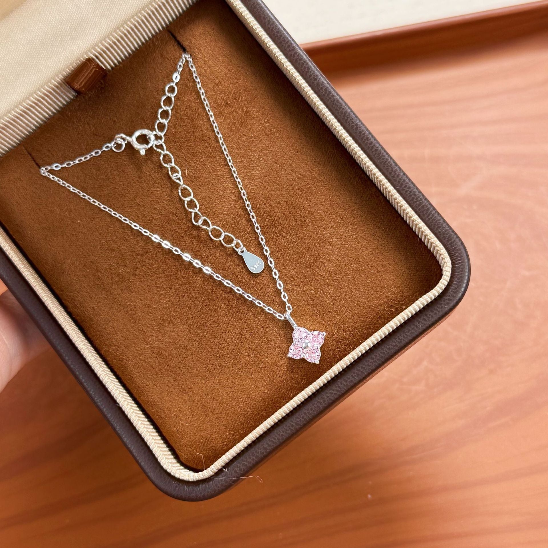 925 sterling silver pink zircon four leaf clover necklace displayed inside a jewelry gift box.