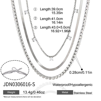 Silver tone triple layer stainless steel necklace with chain lengths and cubic zirconia details