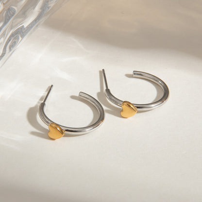 Two tone stainless steel heart hoop earrings flat lay display