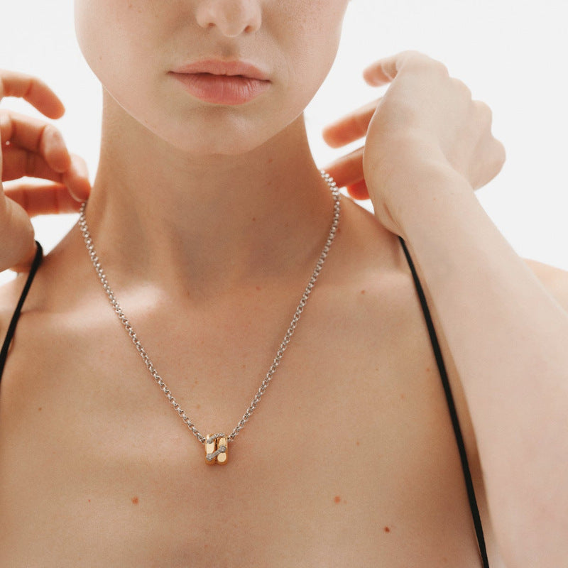 
Model wearing two tone zircon link pendant necklace with minimalist collarbone styling