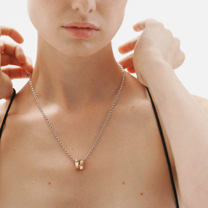 
Model wearing two tone zircon link pendant necklace with minimalist collarbone styling