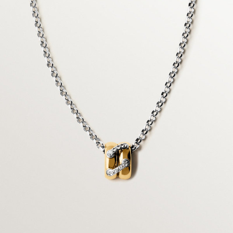 Two tone zircon link pendant necklace with silver tone chain and gold half hoop pendant on white background