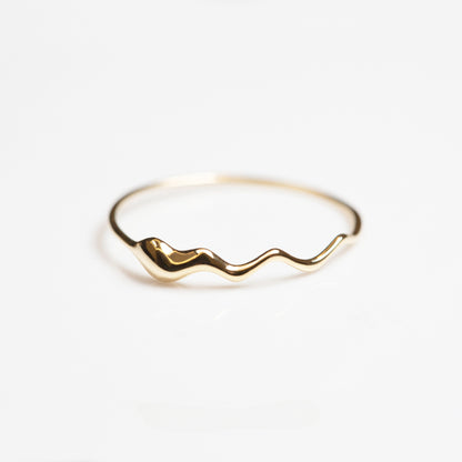 Close up of elegant 18K gold plated sterling silver wave ring with smooth curved details