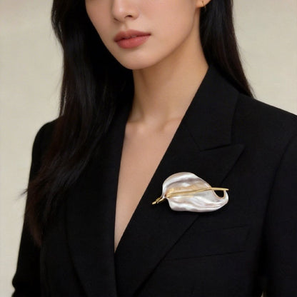 White iris flower brooch styled on a black blazer lapel
